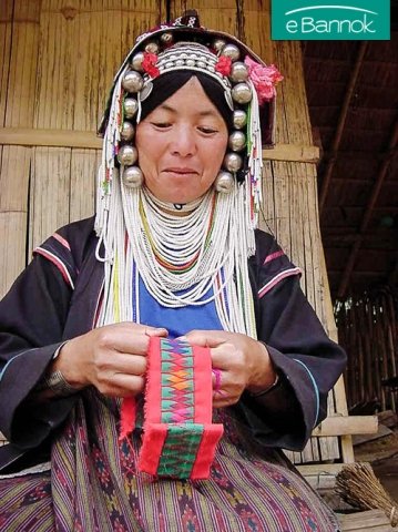 Akha woman sewing traditional embroidered applique