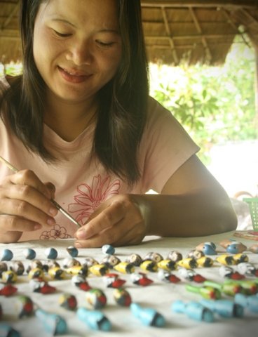Kanya painting clay bird whistles